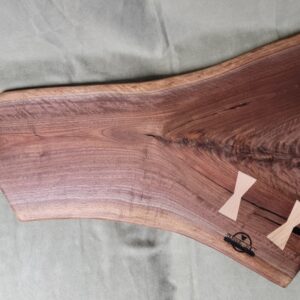 Walnut burl charcuterie board with bow ties.