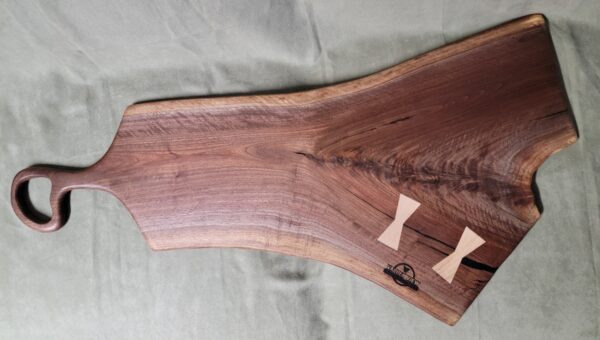 Walnut burl charcuterie board with bow ties.